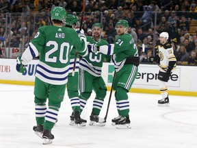 Carolina Hurricanes defenseman Calvin de Haan, center, celebrates with teammates after scoring a goal during the first period of an NHL hockey game against the Boston Bruins, Tuesday, March 5, 2019, in Boston.