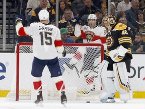 Florida Panthers right wing Troy Brouwer (22) celebrates behind the goal towards teammate Riley Sheahan (15) after scoring past Boston Bruins goaltender Tuukka Rask (40) during the second period of an NHL hockey game, Saturday, March 30, 2019, in Boston.