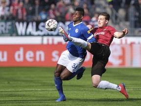 Hannover's Kevin Wimmer, right, and Schalkes Breel Embolo challenge for the ball during the German Bundesliga soccer match between Hannover 96 and FC Schalke 04 in Hannover, Germany, Sunday, Marc 31, 2019.