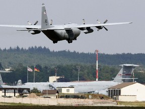 FILE-In this June 27, 2015 file photo an airplane lands at the US Air Base in Ramstein, Germany. A court in Germany has ruled that the government should seek assurances from the United States that drone strikes controlled from German territory are in line with international law.