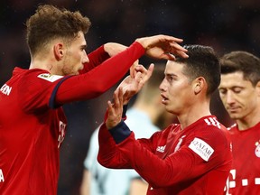 Bayern's James, right, celebrates with teammate Leon Goretzka after scoring during the German Bundesliga soccer match between FC Bayern Munich and 1. FSV Mainz 05 in Munich, Germany, Sunday, March 17, 2019.