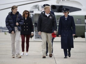 President Donald Trump, first lady Melania Trump and their son Barron Trump, walk to board Air Force One, Friday, March 8, 2019, in Andrews Air Force Base, Md., en route to Lee County, Ala., where tornados killed 23 people.