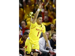 Maryland guard Anthony Cowan Jr. gestures after making a three-point basket in the first half of an NCAA college basketball game against Minnesota, Friday, March 8, 2019, in College Park, Md.