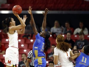 Maryland forward Stephanie Jones, left, shoots over UCLA forward Michaela Onyenwere, second from left, Maryland forward Shakira Austin (1) and UCLA forward Lajahna Drummer during the first half of a second-round game in the NCAA women's college basketball tournament Monday, March 25, 2019, in College Park, Md.