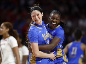 UCLA guard Lindsey Corsaro, left, and forward Michaela Onyenwere celebrate after a second-round game against Maryland in the NCAA women's college basketball tournament Monday, March 25, 2019, in College Park, Md. UCLA won 85-80.