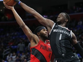 Detroit Pistons guard Reggie Jackson (1) blocks a layup attempt by Portland Trail Blazers forward Maurice Harkless (4) during the first half of an NBA basketball game, Saturday, March 30, 2019, in Detroit.