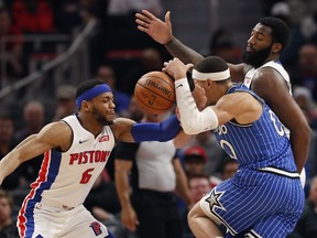 Detroit Pistons guard Bruce Brown (6) knocks the ball away from Orlando Magic forward Aaron Gordon (00) during the first half of an NBA basketball game Thursday, March 28, 2019, in Detroit.