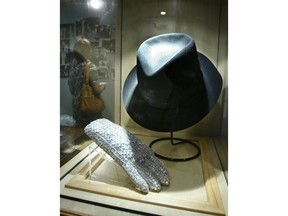 FILE - In this June 21, 2010 file photo, a hat and sequined glove once belonging to Michael Jackson is displayed at the Motown Historical Museum at Hitsville U.S.A. in Detroit. Some fans may be removing Michael Jackson's music from their playlists after a new documentary rekindles allegations of child sexual abuse, but at least two music museums in Detroit and Tennessee aren't scrubbing the King of Pop from their exhibits.