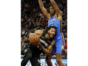 Minnesota Timberwolves' Derrick Rose, left, drives around Oklahoma City Thunder's Terrance Ferguson in the first half of an NBA basketball game Tuesday, March 5, 2019, in Minneapolis.