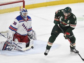 Minnesota Wild's Zach Parise, right, tips the puck past New York Rangers goalie Henrick Lundqvist, of Sweden, in the first period of an NHL hockey game Saturday, March 16, 2019, in St. Paul, Minn.