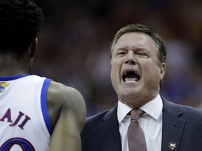 Kansas coach Bill Self talks to players during the first half of the team's NCAA college basketball game against Iowa State in the Big 12 men's tournament final Saturday, March 16, 2019, in Kansas City, Mo.