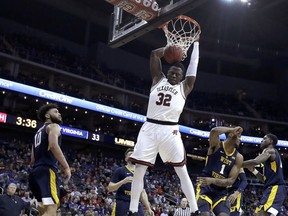 Texas Tech's Norense Odiase (32) dunks during the first half of the team's NCAA college basketball game against West Virginia in the Big 12 men's tournament Thursday, March 14, 2019, in Kansas City, Mo.