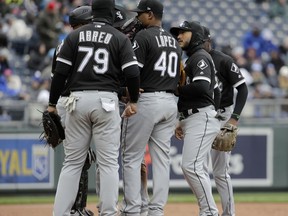 Chicago White Sox players meet on the mound after allowing a run during the third inning of a baseball game against the Kansas City Royals Saturday, March 30, 2019, in Kansas City, Mo.
