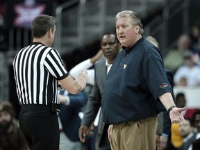 West Virginia head coach Bob Huggins talks to an official during the first half of an NCAA college basketball game against Kansas in the Big 12 men's tournament Friday, March 15, 2019, in Kansas City, Mo.