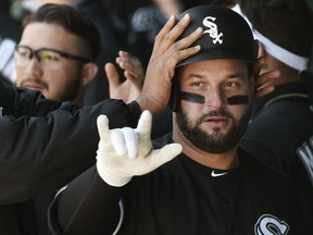 Chicago White Sox's Yonder Alonso celebrates with teammates after hitting a home run in the fourth inning during a baseball game against the Kansas City Royals, Sunday, March 31, 2019, in Kansas City, Mo.