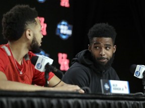 Houston's Corey Davis Jr., right, looks at teammate Galen Robinson Jr. as they take part in a news conference at the NCAA men's college basketball tournament Thursday, March 28, 2019, in Kansas City, Mo. Houston plays Kentucky in a Midwest Regional semifinal on Friday.