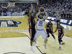 North Carolina's Luke Maye (32) shoots as Auburn's Austin Wiley (50), Chuma Okeke (5) and Samir Doughty (10) defend during the first half of a men's NCAA tournament college basketball Midwest Regional semifinal game Friday, March 29, 2019, in Kansas City, Mo.