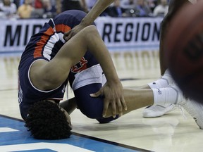 Auburn's Chuma Okeke grabs his leg after being injured on his way to the basket during the second half of a men's NCAA tournament college basketball Midwest Regional semifinal game against North Carolina, Friday, March 29, 2019, in Kansas City, Mo.