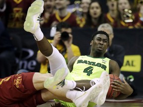Baylor guard Mario Kegler (4) lands on the floor after being fouled by Iowa State forward Michael Jacobson, left, during the first half of an NCAA college basketball game in the quarterfinals of the Big 12 conference tournament in Kansas City, Mo., Thursday, March 14, 2019.