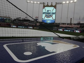 Rain falls on the home team dugout before an opening day baseball game between the Kansas City Royals and the Chicago White Sox at Kauffman Stadium in Kansas City, Mo., Thursday, March 28, 2019.