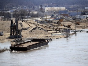 A barge is moored along the Missouri River as floodwaters begin to creep into a dredge operation in St Joseph, Mo., Monday, March 18, 2019.