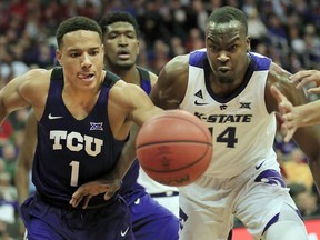 TCU guard Desmond Bane (1) and Kansas State forward Makol Mawien (14) chase a loose ball during the first half of an NCAA college basketball game in the quarterfinals of the Big 12 conference tournament in Kansas City, Mo., Thursday, March 14, 2019.
