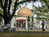 An armed police officer patrols outside the Al Noor mosque where a makeshift memorial to shooting victims has grown, on March 22, 2019 in Christchurch, New Zealand.