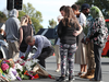 Locals lay flowers in tribute to those killed and injured near the Al Noor Mosque on March 16, 2019 in Christchurch, New Zealand.