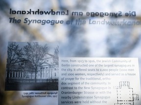 In this Wednesday, March 20, 2019, a remembrance plague displays information and a photo of the former 'Fraenkelufer' synagogue, in Berlin, Wednesday, March 20, 2019. The synagogue was able to receive about 2000 prayers before it was destroyed by the Nazis. In the German capital, efforts are underway to rebuild the synagogue.