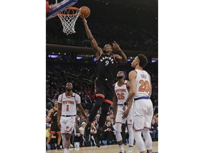 Toronto Raptors' Serge Ibaka (9) drives past New York Knicks' Kevin Knox (20) during the first half of an NBA basketball game Thursday, March 28, 2019, in New York.