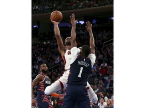 Miami Heat's Dwyane Wade shoots over New York Knicks' Emmanuel Mudiay during the first half of an NBA basketball game Saturday, March 30, 2019, in New York.