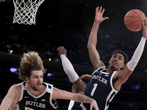 Butler forward Jordan Tucker (1) goes up for a rebound against Providence center Nate Watson, center, during the first half of an NCAA college basketball game in the Big East men's tournament, Wednesday, March 13, 2019, in New York. Butler's Joey Brunk is at left.