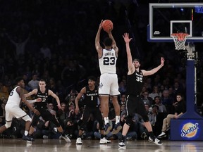 Villanova forward Jermaine Samuels (23) shoots against Xavier forward Zach Hankins (35) during overtime of an NCAA college basketball semifinal game in the Big East men's tournament, Friday, March 15, 2019, in New York. Villanova won 71-67 in overtime.