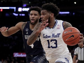 Seton Hall guard Myles Powell (13) drives against Georgetown guard Jagan Mosely (4) during the first half of an NCAA college basketball game in the Big East men's tournament, Thursday, March 14, 2019, in New York.