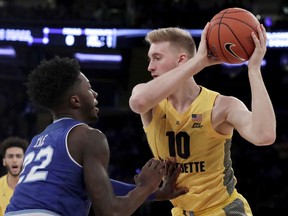 Marquette forward Sam Hauser, right, is defended by Seton Hall guard Myles Cale (22) during the first half of an NCAA college basketball semifinal game in the Big East men's tournament, Friday, March 15, 2019, in New York.