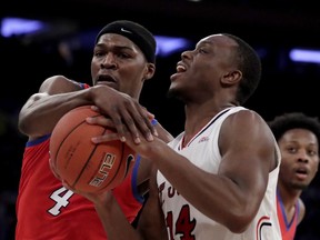 St. John's guard Mustapha Heron (14) tries for a shot against DePaul forward Paul Reed (4) during the first half of an NCAA college basketball game in the Big East men's tournament, Wednesday, March 13, 2019, in New York.