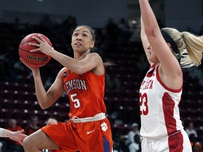 Clemson guard Danielle Edwards (5) attempts a layup while South Dakota guard Madison McKeever (23) defends during a first round women's college basketball game in the NCAA Tournament in Starkville, Miss., Friday, March 22, 2019.