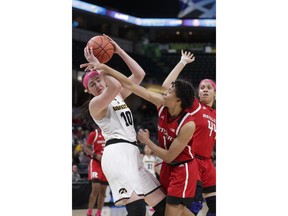 Rutgers guard Zipporah Broughton (1) fouls Iowa forward Megan Gustafson (10) in the first half of an NCAA college basketball semifinal game at the Big Ten Conference tournament in Indianapolis, Saturday, March 9, 2019.