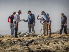 Foreign investigators examine wreckage at the scene where the Ethiopian Airlines Boeing 737 Max 8 crashed shortly after takeoff on Sunday killing all 157 on board, near Bishoftu, or Debre Zeit, south of Addis Ababa, in Ethiopia Tuesday, March 12, 2019. Ethiopian Airlines had issued no new updates on the crash as of late afternoon Tuesday as families around the world waited for answers, while a global team of investigators began picking through the rural crash site.