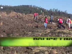 In this image taken from video, rescuers search through wreckage at the scene of an Ethiopian Airlines flight that crashed shortly after takeoff at Hejere near Bishoftu, or Debre Zeit, some 50 kilometers (31 miles) south of Addis Ababa, in Ethiopia Sunday, March 10, 2019. The Ethiopian Airlines flight crashed shortly after takeoff from Ethiopia's capital on Sunday morning, killing all 157 on board, authorities said, as grieving families rushed to airports in Addis Ababa and the destination, Nairobi.