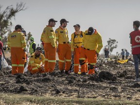 Investigators from Israel examine wreckage at the scene where the Ethiopian Airlines Boeing 737 Max 8 crashed shortly after takeoff on Sunday killing all 157 on board, near Bishoftu, or Debre Zeit, south of Addis Ababa, in Ethiopia Tuesday, March 12, 2019. Ethiopian Airlines had issued no new updates on the crash as of late afternoon Tuesday as families around the world waited for answers, while a global team of investigators began picking through the rural crash site.