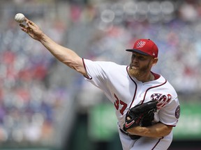 Washington Nationals starting pitcher Stephen Strasburg delivers a pitch during the first inning of a baseball game against the New York Mets, Saturday, March 30, 2019, in Washington.