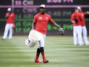 Washington Nationals center fielder Victor Robles (16) carries a bucket of baseballs before an exhibition baseball game against the New York Yankees, Monday, March 25, 2019, in Washington.