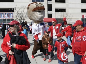 Teddy, one of the racing presidents, greets fans at the gates before a baseball game between the Washington Nationals and the New York Mets, Thursday, March 28, 2019, in Washington.