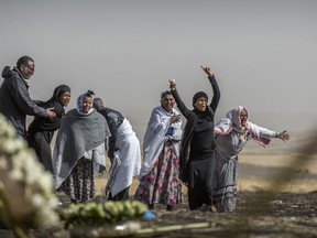 Ethiopian relatives of crash victims grieve at the site where the Ethiopian Airlines Boeing 737 Max 8 crashed shortly after takeoff on Sunday killing all 157 on board, near Bishoftu, south-east of Addis Ababa, in Ethiopia, on Thursday, March 14, 2019.