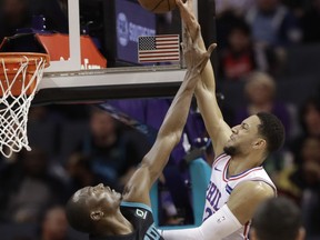 Philadelphia 76ers' Ben Simmons (25) is fouled by Charlotte Hornets' Bismack Biyombo (8) during the first half of an NBA basketball game in Charlotte, N.C., Tuesday, March 19, 2019.