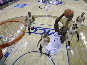 Duke's Zion Williamson (1) goes up to dunk against Florida State during the first half of the NCAA college basketball championship game of the Atlantic Coast Conference tournament in Charlotte, N.C., Saturday, March 16, 2019.