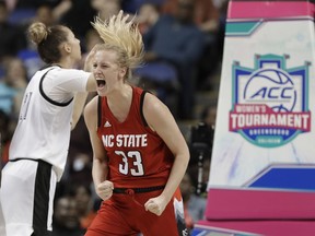 North Carolina State's Elissa Cunane (33) reacts after making a basket against Louisville during the first half of an NCAA college basketball game in the Atlantic Coast Conference women's tournament in Greensboro, N.C., Saturday, March 9, 2019.