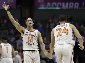 Virginia Tech's Ahmed Hill (13) reacts as he congratulates Kerry Blackshear Jr. (24) after a basket against Miami during the first half of an NCAA college basketball game in the Atlantic Coast Conference tournament in Charlotte, N.C., Wednesday, March 13, 2019.