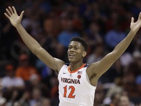 Virginia's De'Andre Hunter (12) reacts after making a basket against North Carolina State during the second half of an NCAA college basketball game in the Atlantic Coast Conference tournament in Charlotte, N.C., Thursday, March 14, 2019.